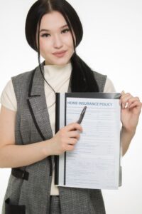 A family reviews health insurance paperwork together at a kitchen table.