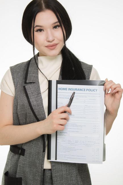 A family reviews health insurance paperwork together at a kitchen table.
