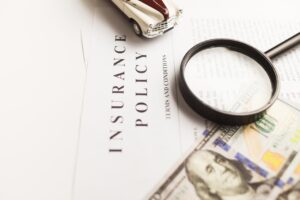 Small business owners reviewing insurance documents together at an office desk.